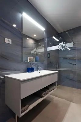 a bathroom with a white sink and a mirror at Villa EVA Resort & Boutique in Dobrovo