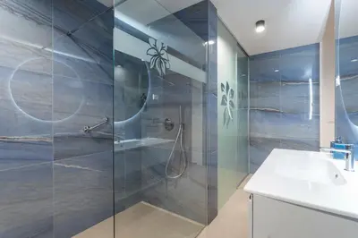a bathroom with a shower and a sink at Villa EVA Resort & Boutique in Dobrovo