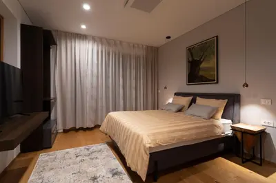 a bedroom with a large bed and a television at Villa EVA Resort & Boutique in Dobrovo