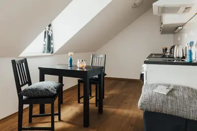 a kitchen with a table and chairs in a room at Layer Residences in Kranj