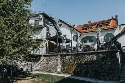a large white house with a fence at Layer Residences in Kranj