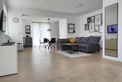 a living room with a couch and a table at Apartma WALK in in Brežice