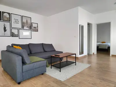a living room with a couch and a table at Apartma WALK in in Brežice