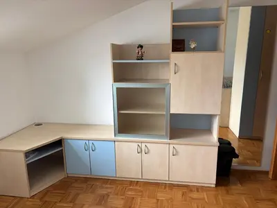 a room with a desk and shelves at Trnovo Lunca Apartment in Ljubljana