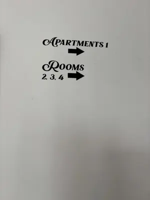 a sign that says apartments and rooms with arrows at Trnovo Lunca Apartment in Ljubljana