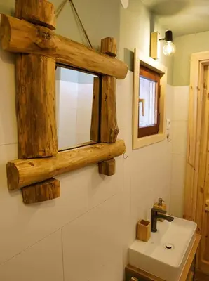 a bathroom with a wooden mirror and a sink at Chalet Slavko in Bohinjska Bistrica