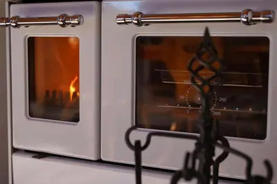 a white oven with a fire inside of it at Chalet Slavko in Bohinjska Bistrica