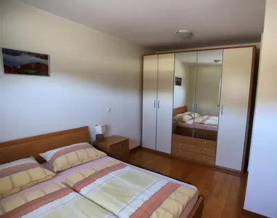 a bedroom with a bed and a large mirror at Apartment Harper in Bohinj