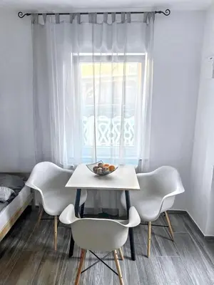 a table and chairs with a bowl of fruit on it at Vesna Studios in Ljubljana
