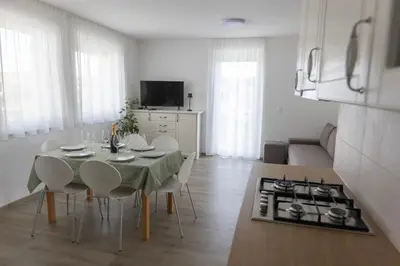 a kitchen and dining room with a table and chairs at Villa Andrea Apartments - Ljubljana in Ljubljana