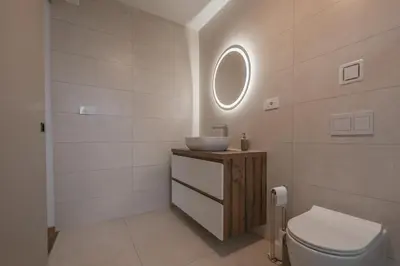 a bathroom with a sink and a toilet at Villa Brje with Seasonal Pool in Dobravlje