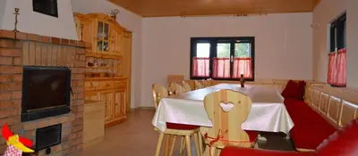 a dining room with a table and chairs and a tv at Brunarica Petric - Bela krajina - Komarna vas - Smučišče Gače - Semič in Komarna Vas
