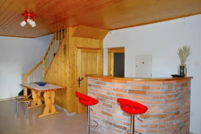 a room with a table and chairs and a brick wall at Brunarica Petric - Bela krajina - Komarna vas - Smučišče Gače - Semič in Komarna Vas