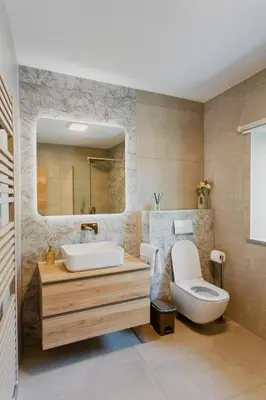 a bathroom with a sink and a toilet and a mirror at Hiša Skala Kubed in Gračišče