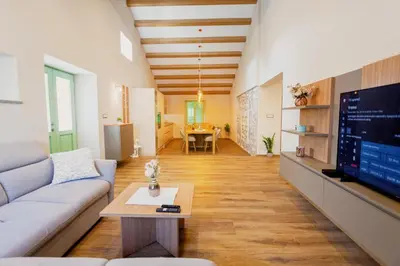 a living room with a couch and a tv at Hiša Skala Kubed in Gračišče
