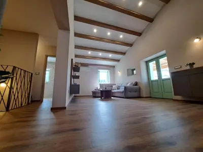 a large living room with a couch and a table at Hiša Skala Kubed in Gračišče
