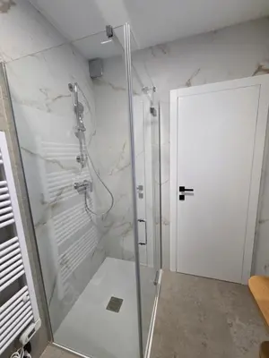 a shower with a glass door in a bathroom at Vila Natalia in Kranjska Gora