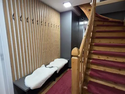 a room with a staircase with snow blankets on the seats at Vila Natalia in Kranjska Gora