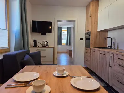a kitchen and a table with two plates on it at Vila Natalia in Kranjska Gora