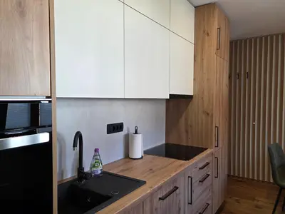 a kitchen with white cabinets and a sink and a counter at Vila Natalia in Kranjska Gora