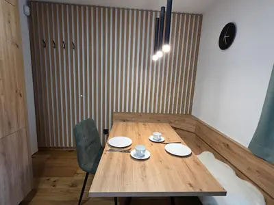 a wooden table with two cups and plates on it at Vila Natalia in Kranjska Gora