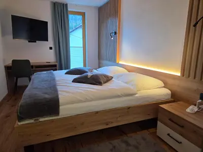a bed with two pillows on it in a bedroom at Vila Natalia in Kranjska Gora
