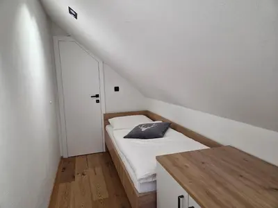 a bedroom with a bed with a pillow on it at Vila Natalia in Kranjska Gora