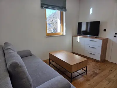 a living room with a couch and a tv at Vila Natalia in Kranjska Gora