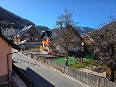 a view of a street in a village with a fence at Vila Natalia in Kranjska Gora