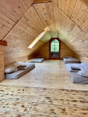 a room with three beds in a wooden room at Chalet on Pohorje hill Maribor bike park next to the downhill track in Pohorje