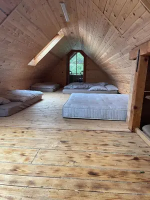 a room with three beds in a wooden attic at Chalet on Pohorje hill Maribor bike park next to the downhill track in Pohorje