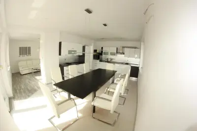 a dining room with a black table and white chairs at Bella Vita in Postojna