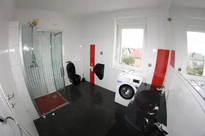 a bathroom with a shower and a washing machine at Bella Vita in Postojna