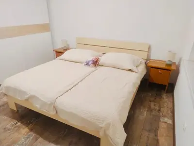 a bedroom with a bed with a pillow and a night stand at Bella Vita in Postojna