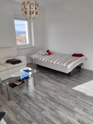 a white living room with a bed and a couch at Bella Vita in Postojna