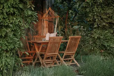 two chairs and a table in a garden at Private Eco Cottage in Nature in Šulinci