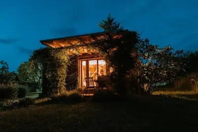 a small house with a window in a field at Private Eco Cottage in Nature in Šulinci