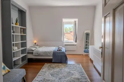 a bedroom with a bed and a window at Central Castle View Apartment in Ljubljana