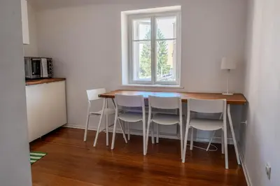 a kitchen with a table with chairs and a window at Central Castle View Apartment in Ljubljana