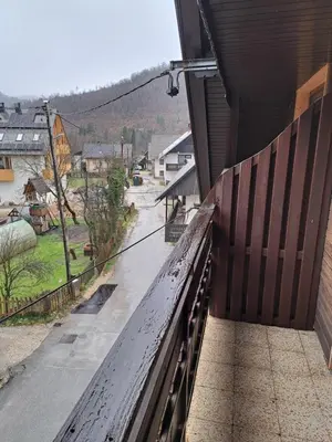 a balcony of a building with a view of a street at Hiša Bistrica in Bohinj