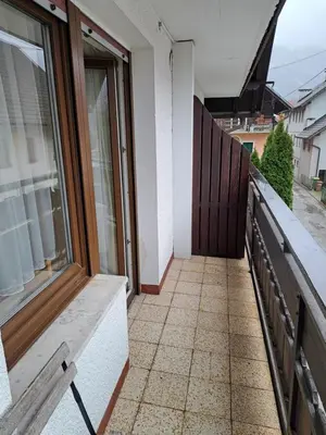 a balcony of a house with a window at Hiša Bistrica in Bohinj