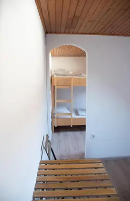 a room with a bench and a bunk bed at Hiša Bistrica in Bohinj