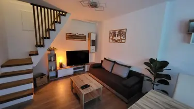 a living room with a couch and a tv at Apartma Leila in Bohinj