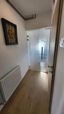 a room with a hallway with a glass door at Apartma Leila in Bohinj