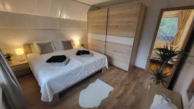 a bedroom with a large bed with two towels on it at Apartma Leila in Bohinj