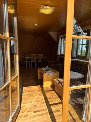 a living room with a couch and a table at BOLFI LUX Apartma z balkonom in Pohorje