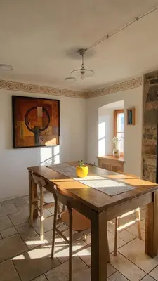 a dining room with a wooden table with a fruit on it at Hiša Manira in Ajdovščina