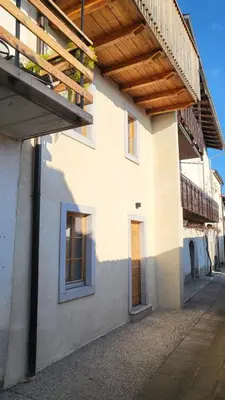 a building with a porch and a wooden roof at Hiša Manira in Ajdovščina
