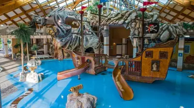 a childrens play area with slides and a playground at Spa Cottage the Moon house Terme Čatež in Čatež ob Savi