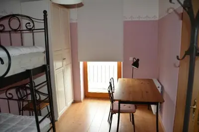 a room with a table and a bunk bed at Hiša 1907 in Bled